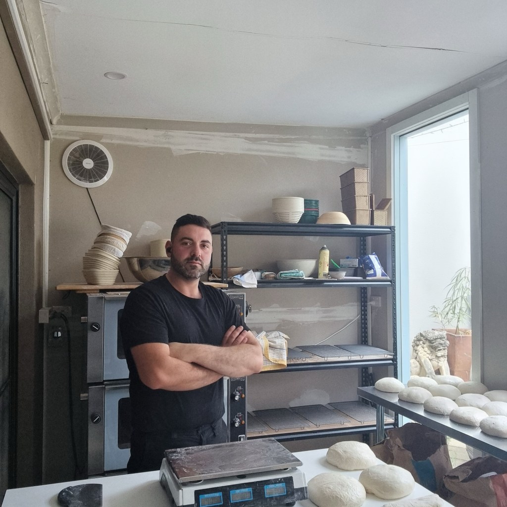 Giuseppe Nasti working inside his Healthy Nasti Kitchen microbakery in 2023
